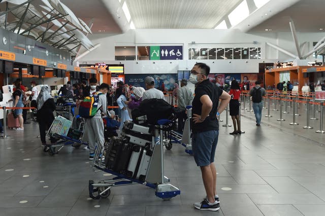<p>File. Passengers wearing masks at Kuala Lumpur airport in Sepang</p>