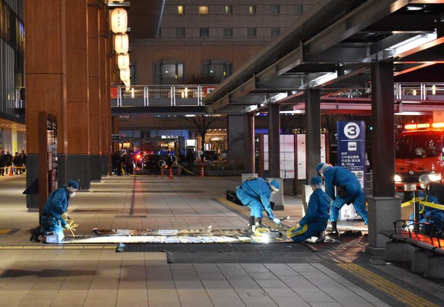 <p>File. Investigators inspect the scene outside the JR Nagano train station after a man stabbed three people at a bus stop in the city of Nagano, some 225km (140 miles) northwest of Tokyo on 22 January 2025</p>