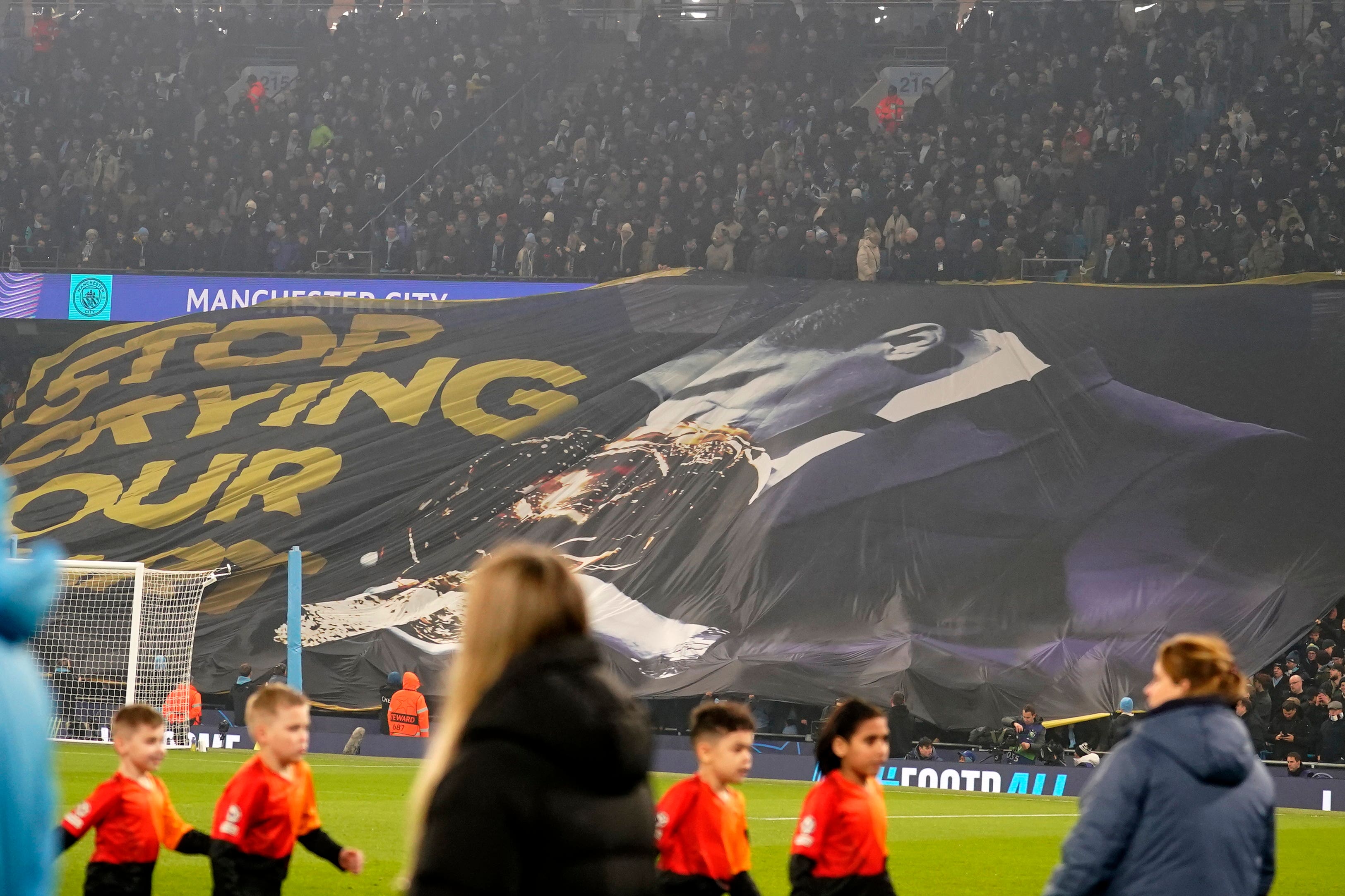 Manchester City’s fans hold up a banner reading 'Stop crying your heart out' with a picture of Rodri kissing the Ballon d'Or trophy, before the Champions League clash with Real Madrid