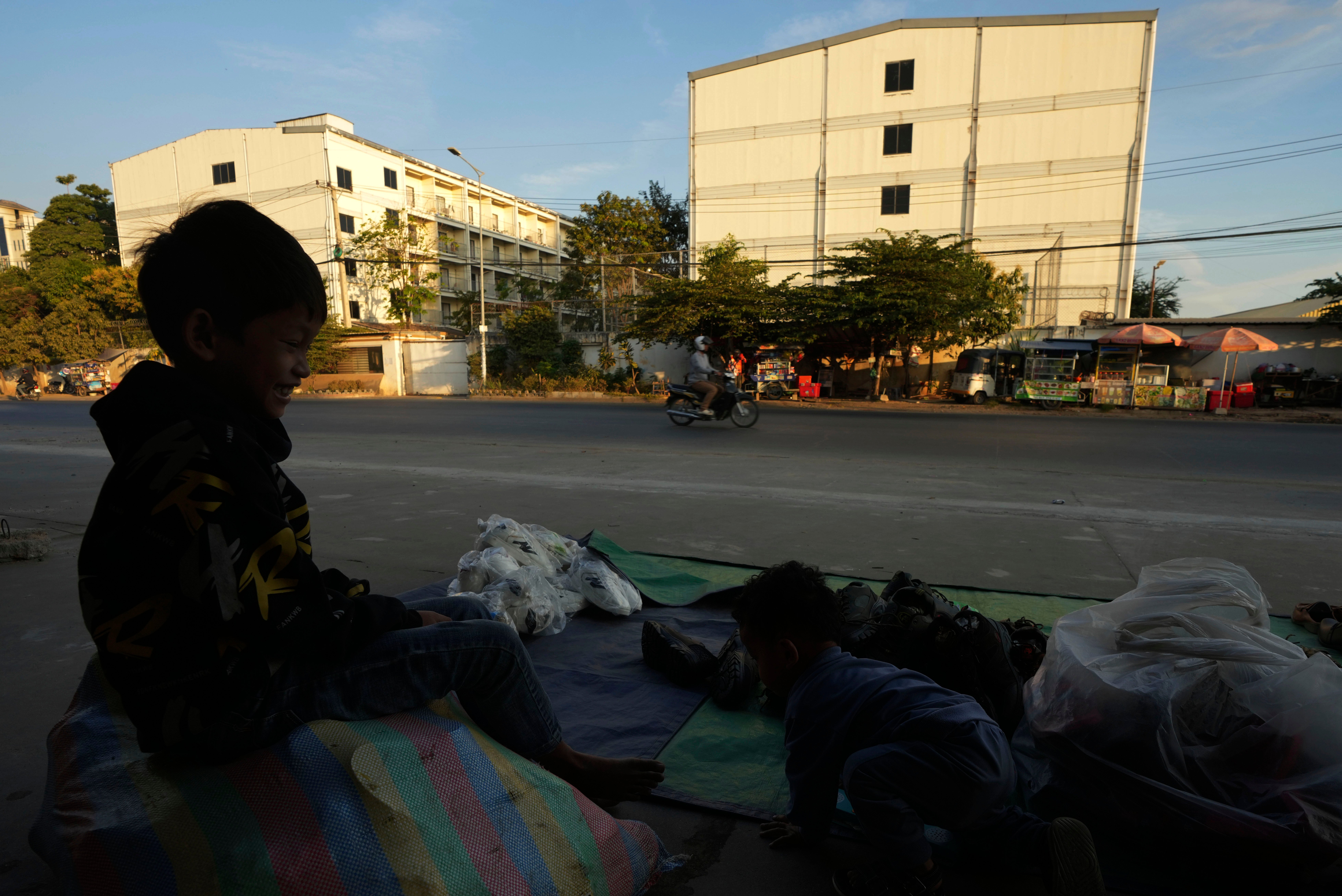 <p>File A boy plays near a building, where people trafficked under false pretenses are forced to work in online scams targeting people all over the world, in Phnom Penh, Cambodia</p>