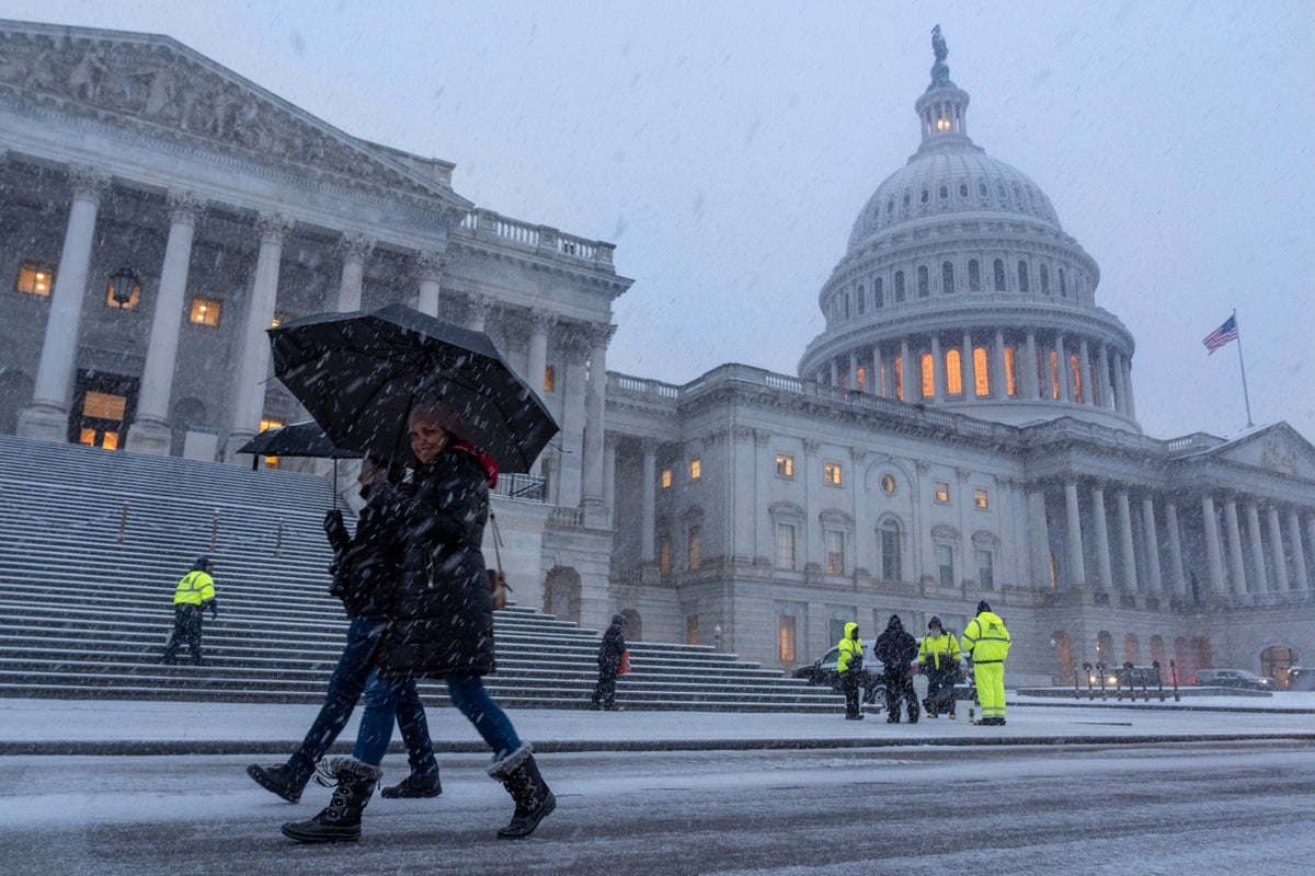 Snow and freezing rain pummel the mid-Atlantic while California prepares for likely flooding