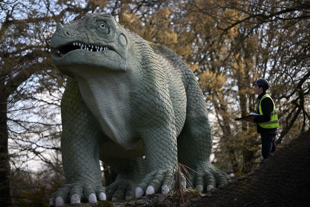 An engineer inspects one of Crystal Palace Park’s resident dinosaurs