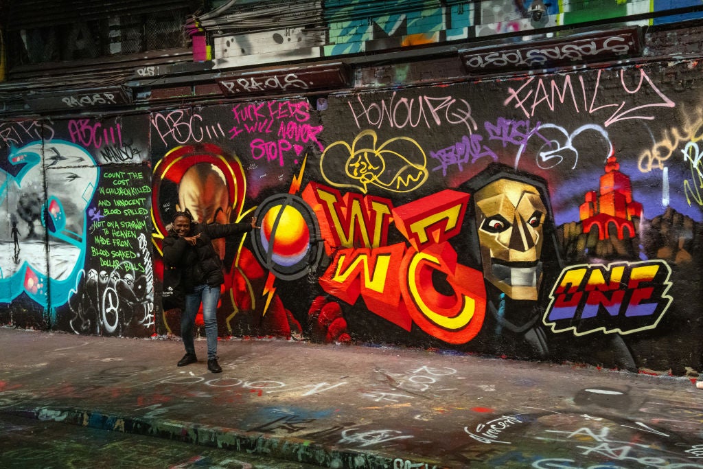 Pose in front of street art at Leake Street Arches