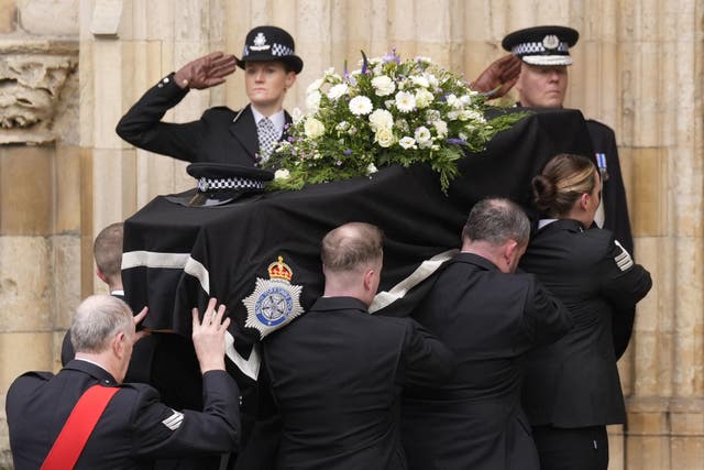 Police salute as the coffin is carried into York Minister for the funeral of constable Rosie Prior (Danny Lawson/PA)
