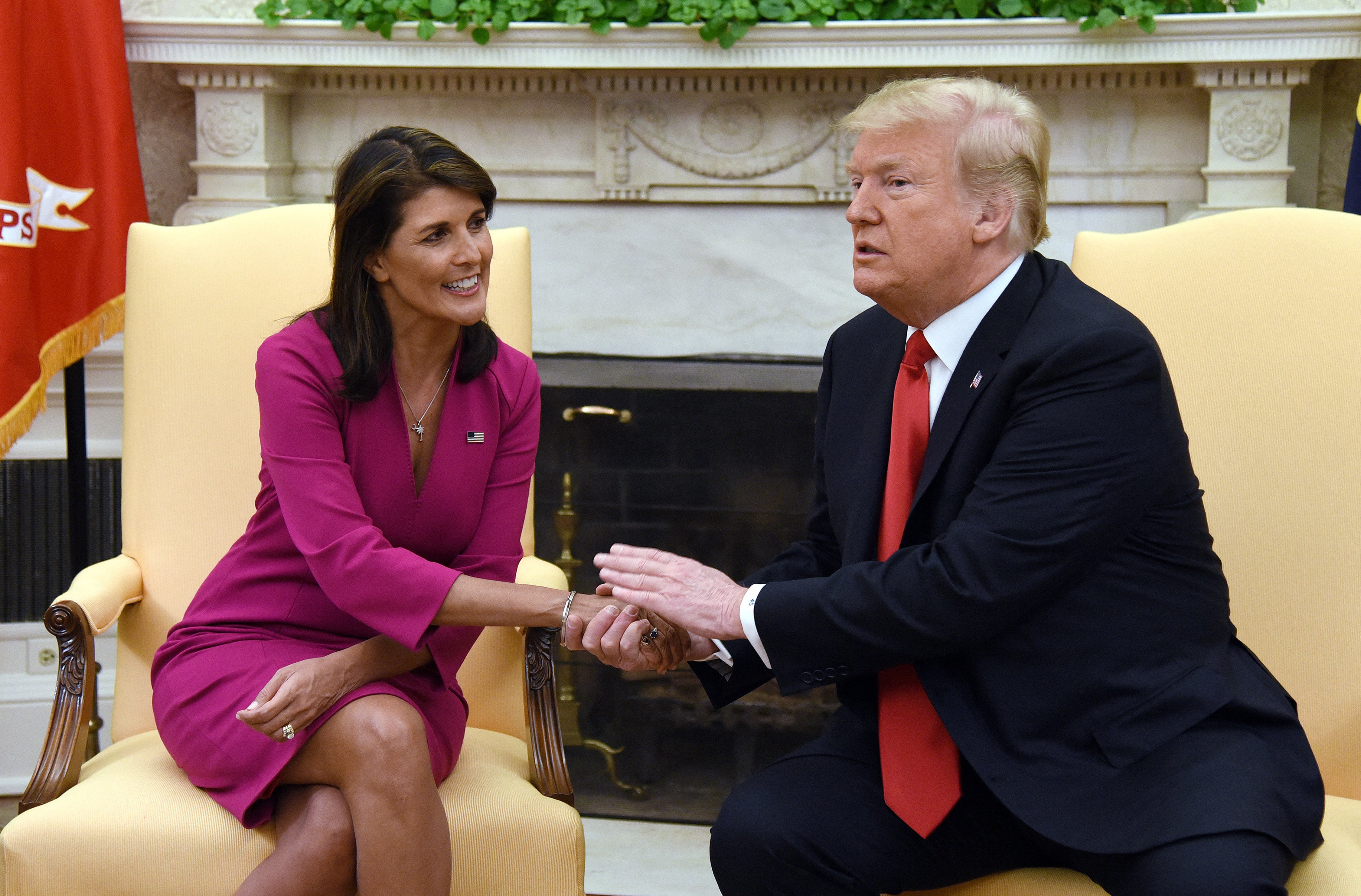 U.S. President Donald Trump shakes hands with Nikki Haley, the then-United States Ambassador to the United Nations in 2018