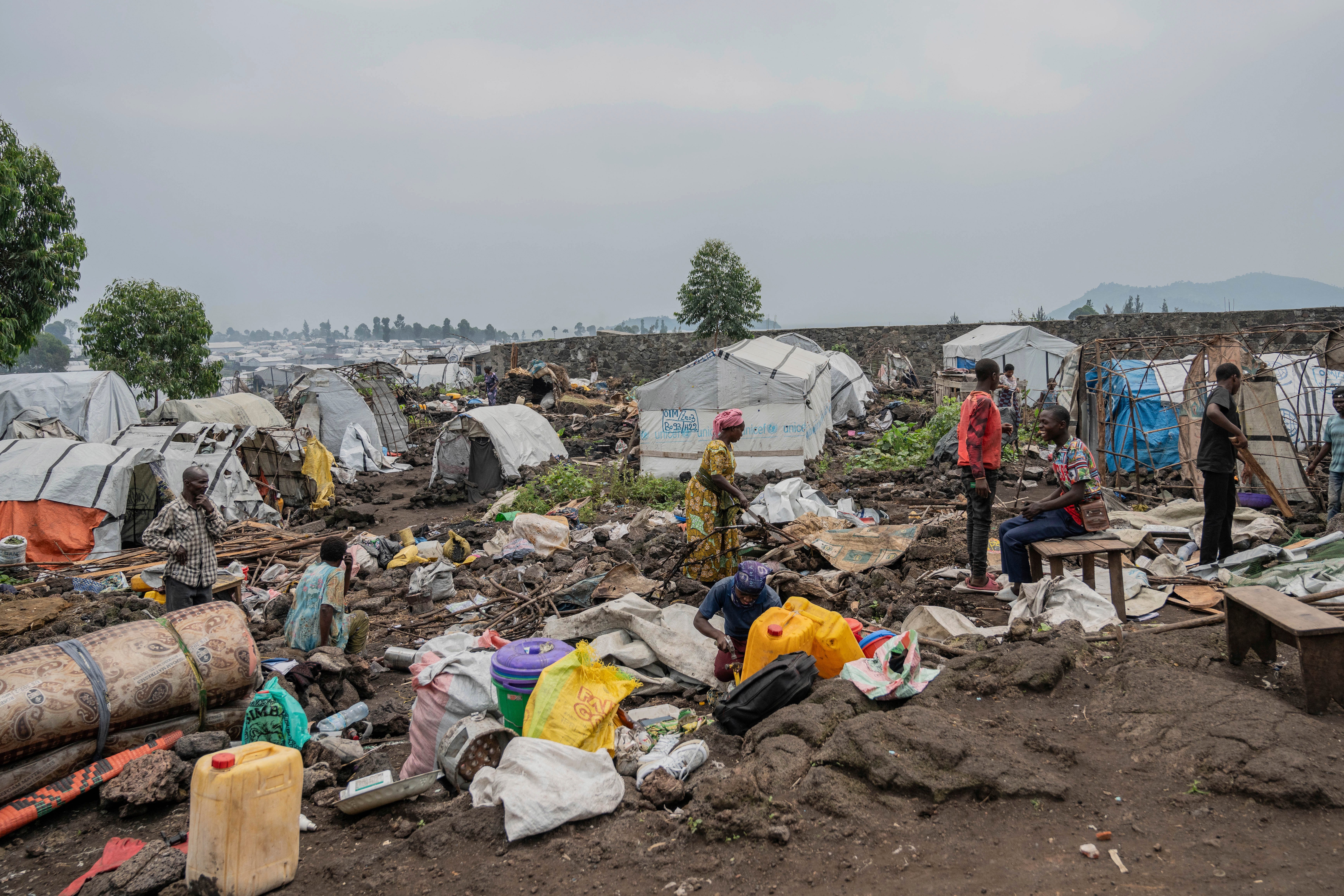 Displaced people prepare to leave a camp in eastern Congo