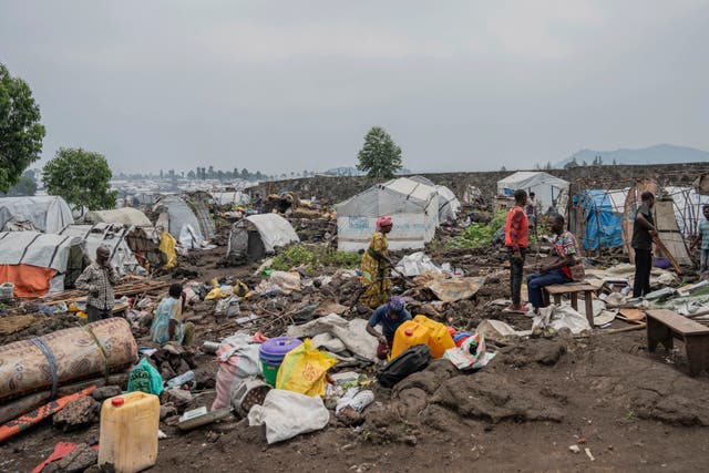 <p>Displaced people prepare to leave a camp in eastern Congo</p>