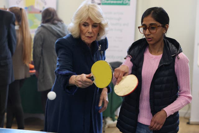 Queen Camilla plays table tennis with Alesha Hussain, 15 (Phil Noble/PA)