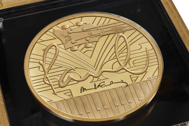 Coins celebrating Sir Paul McCartney are being put up for auction (Royal Mint/PA)
