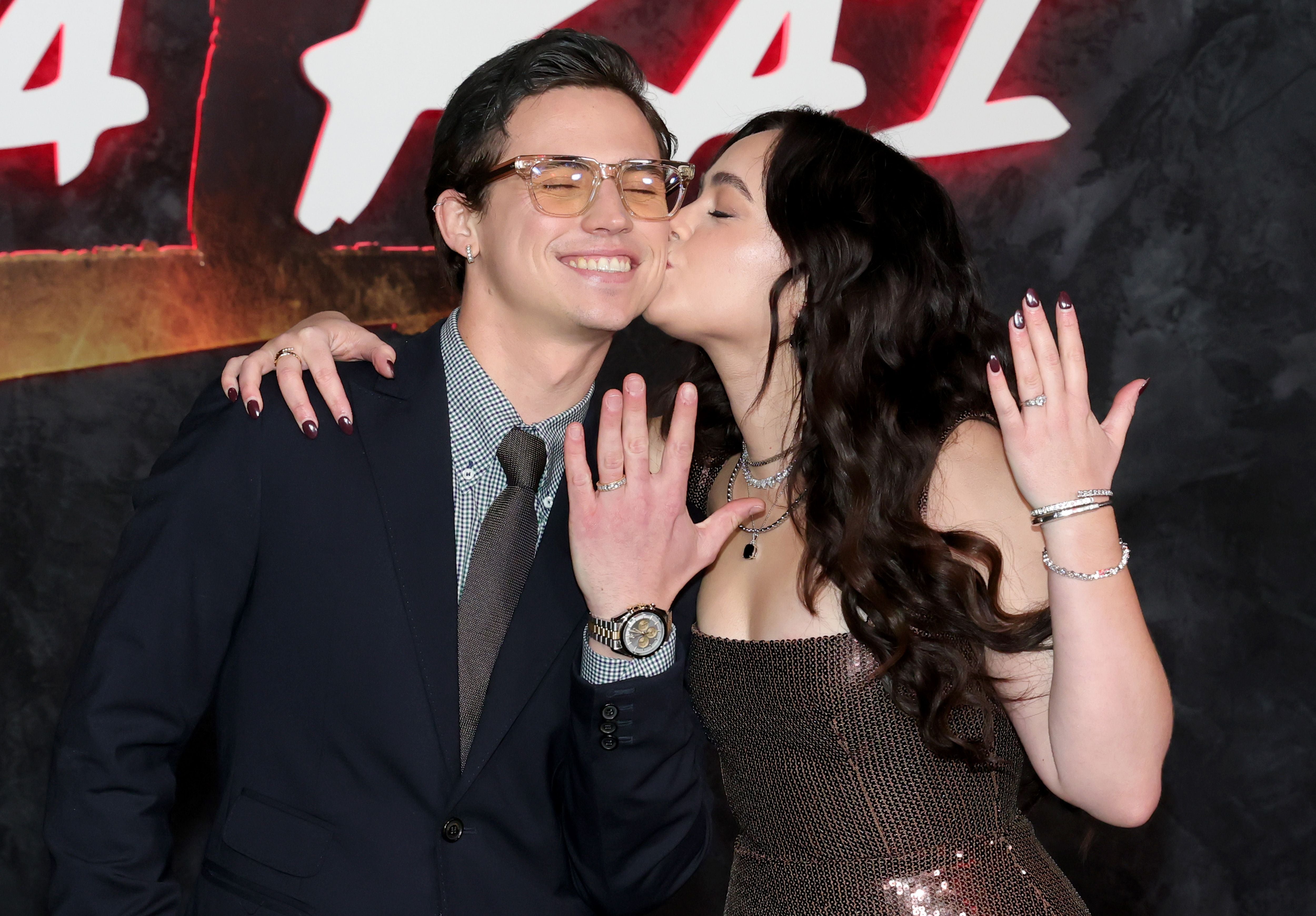 Tanner Buchanan and Mary Mouser show their matching rings on red carpet