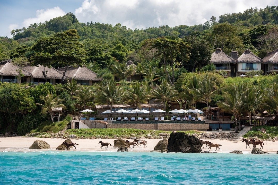 The herd of horses at Nihi Sumba gallops along the beach to reach their grazing