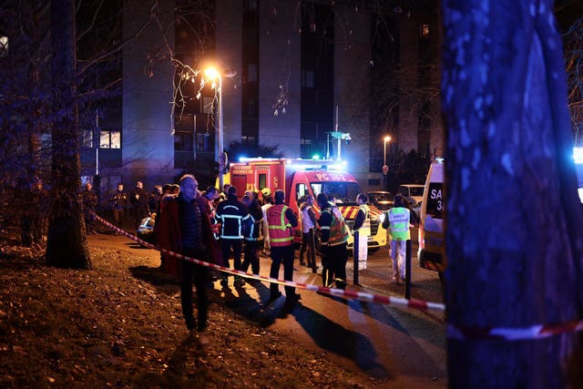 <p>Emergency services work near the scene of the explosion at a bar where a grenade was thrown in Grenoble</p>