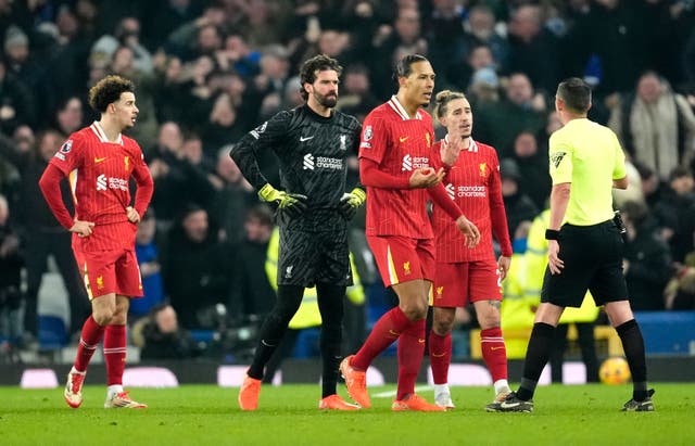 <p>Liverpool's Virgil van Dijk and players speak to referee Michael Oliver</p>