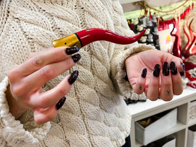 <p>Delia D’Alessandro explains the origins and use of the Neapolitan horn in the family’s shop in Naples</p>