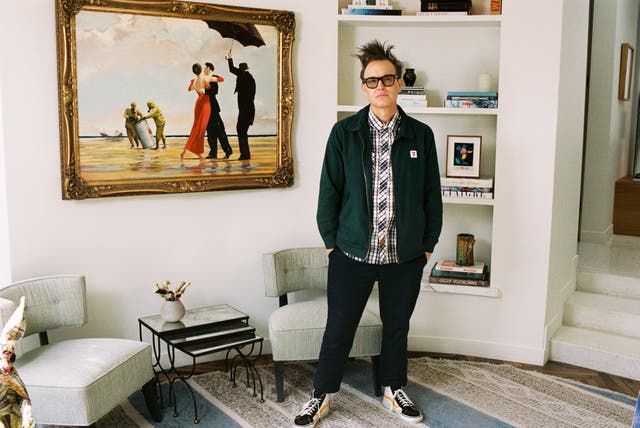 <p>Mark Hoppus with his Banksy painting</p>