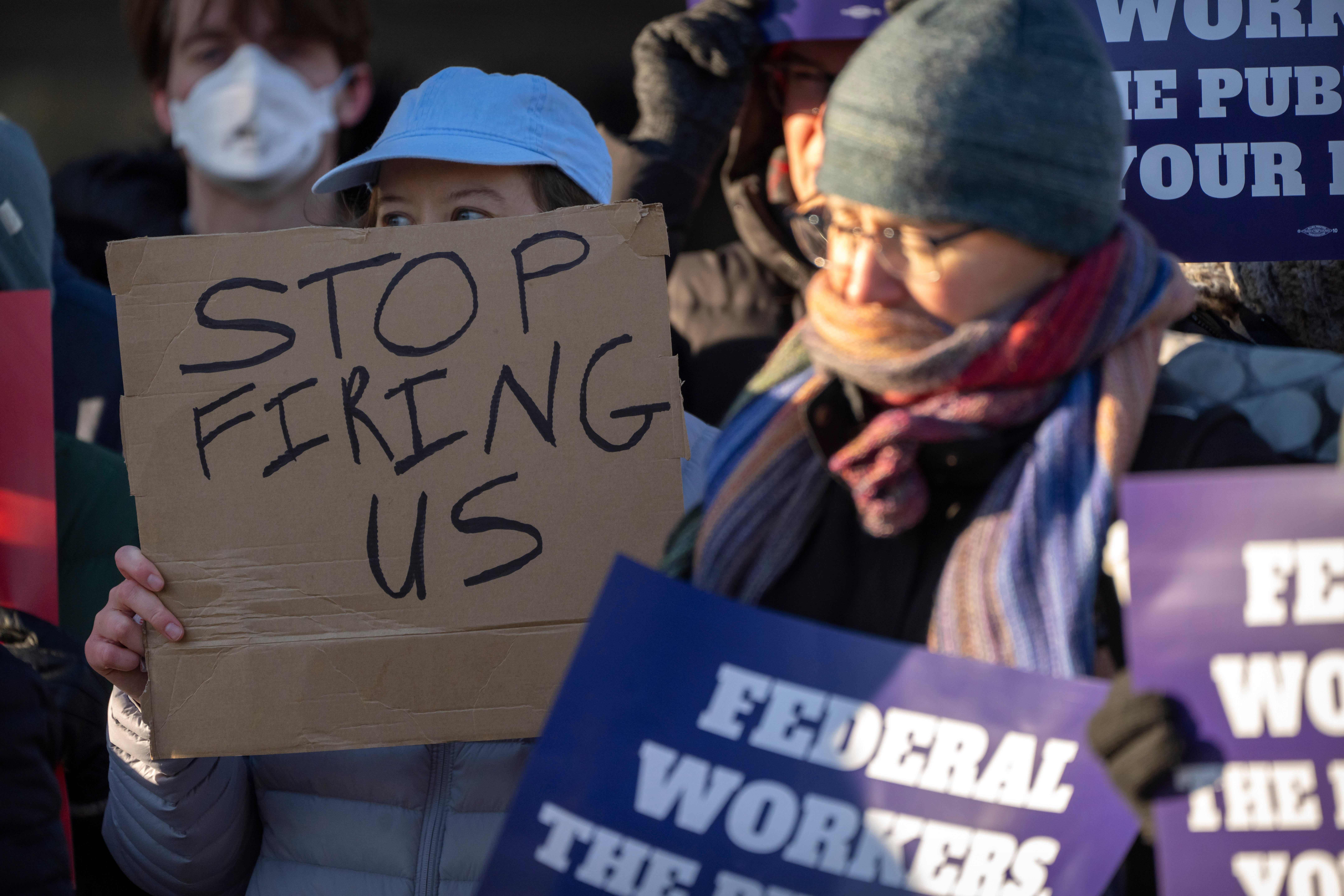 Demonstrators rally in support of federal workers outside of the Department of Health and Human Services, on February 14 in Washington, D.C.