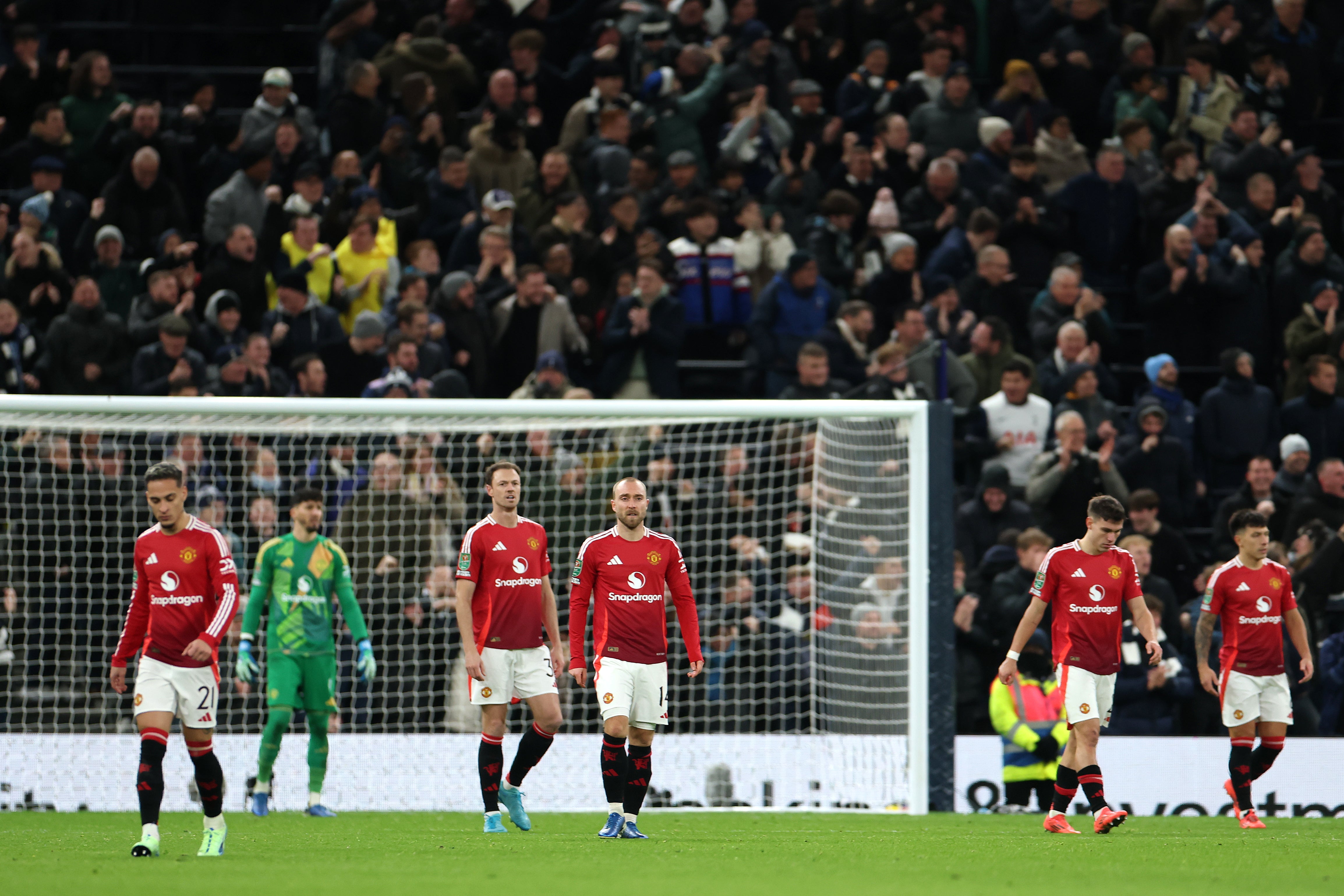 Manchester United players react after conceding against Spurs in their Carabao Cup quarter-final defeat in December