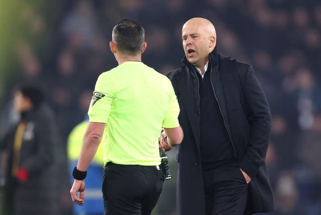 <p>Arne Slot engaged in an intense handshake with referee Michael Oliver</p>