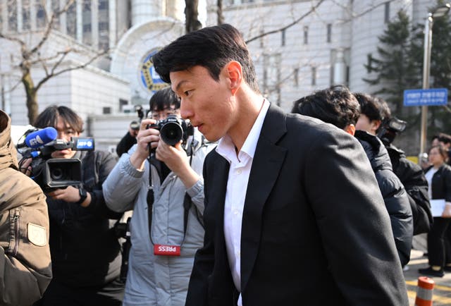 <p>South Korean footballer Hwang Ui-jo leaves after receiving a sentence over his sex-video scandal at the Seoul Central District Court in Seoul on 14 February 2025</p>