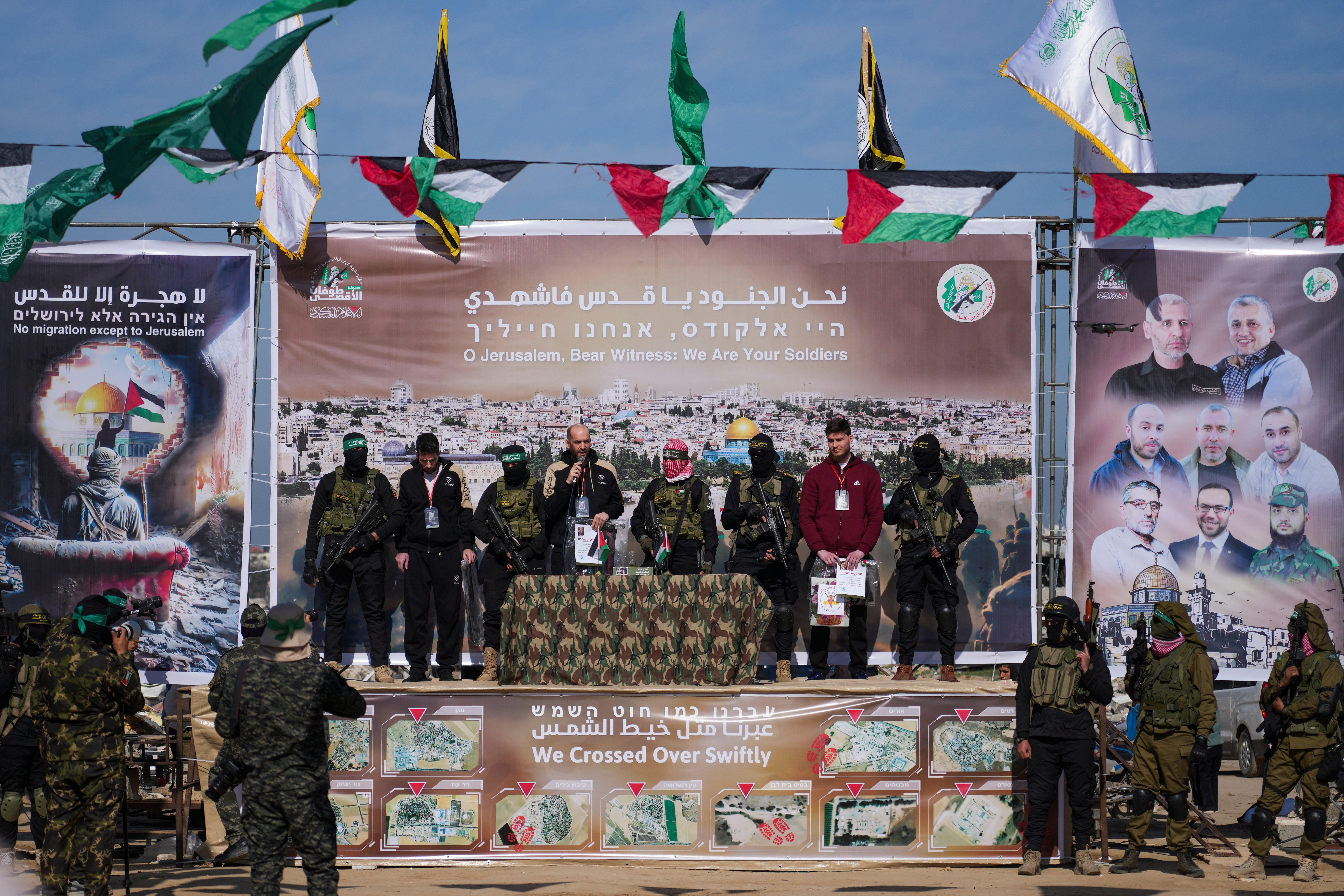 Three hostages held in Gaza, from left, American-Israeli Sagui Dekel Chen, Argentinian-Israeli Iair Horn and Russian-Israeli Alexander (Sasha) Troufanov, are escorted by Hamas and Islamic Jihad fighters