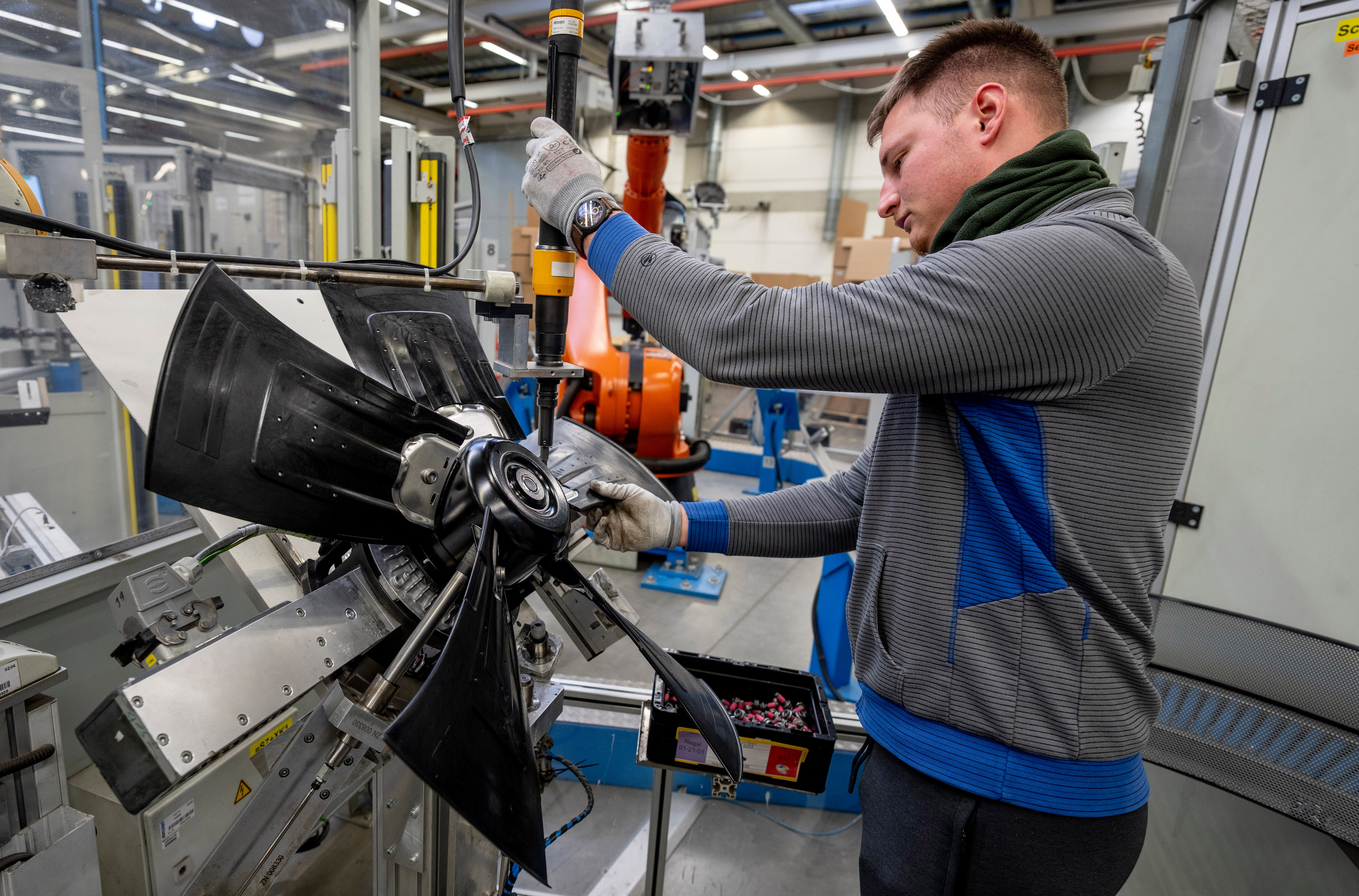 A man works on fans at an EBM-Papst plant in Hollenbach