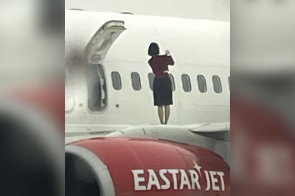 Backlash after flight attendants caught taking photos on plane wing