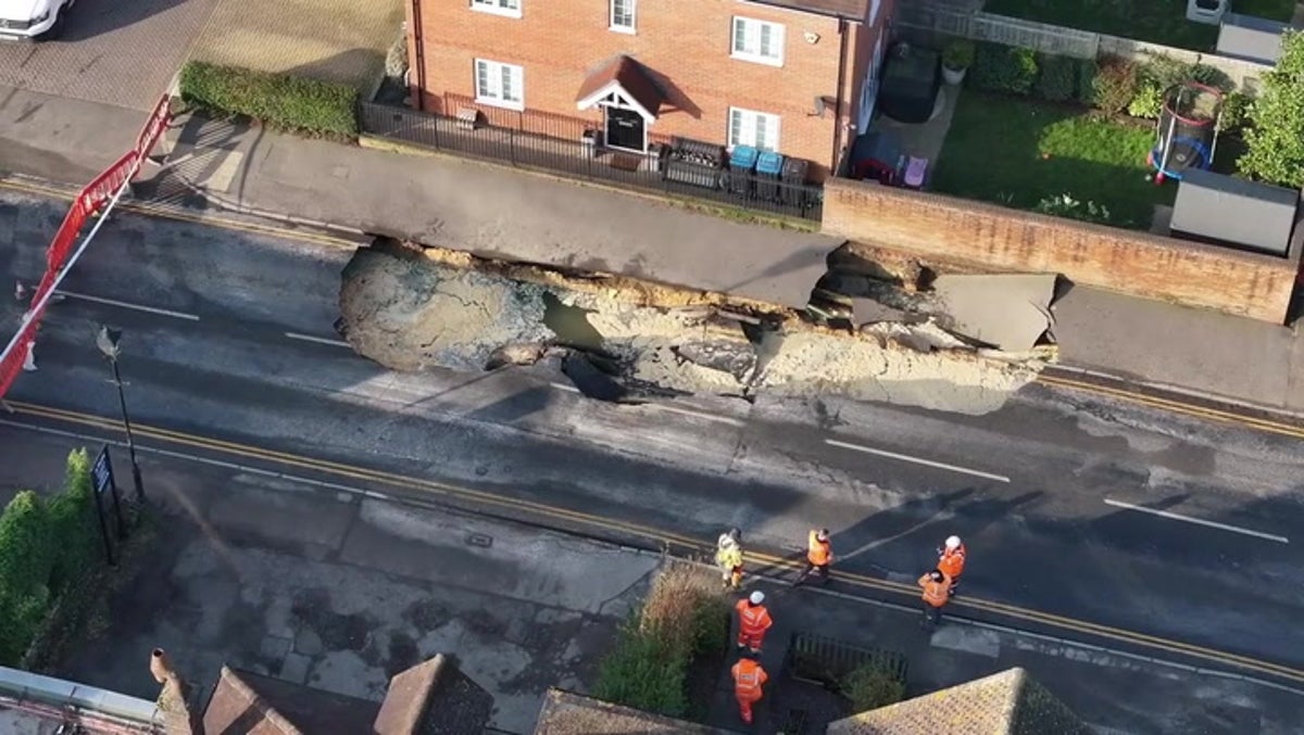 Massive 60ft sinkhole opens in middle of UK high street as buildings forced to evacuate