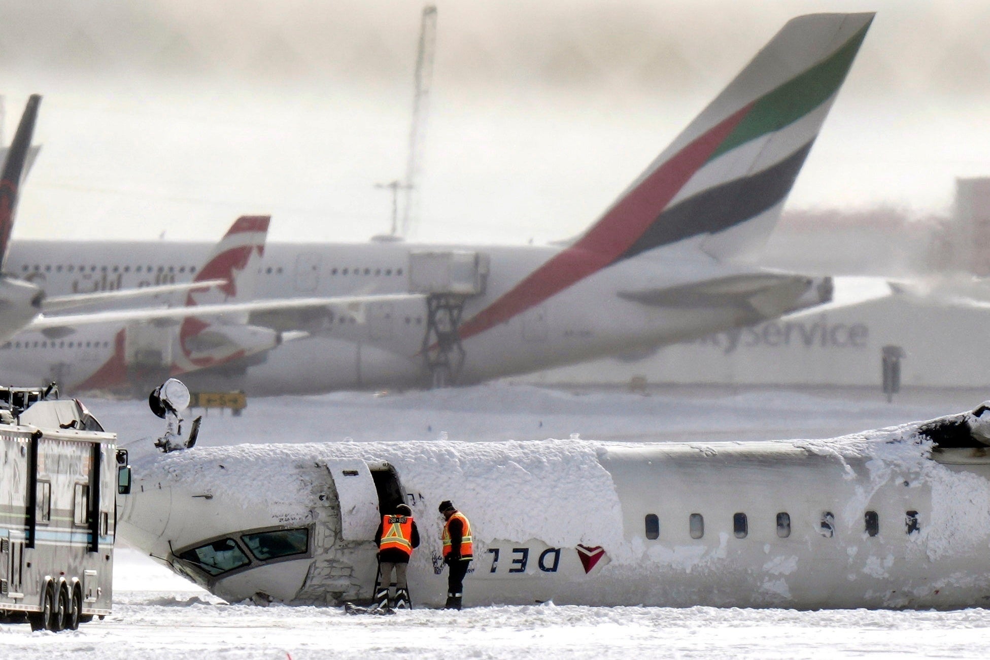 The Delta plane lies upside down at Toronto Pearson airport on Tuesday