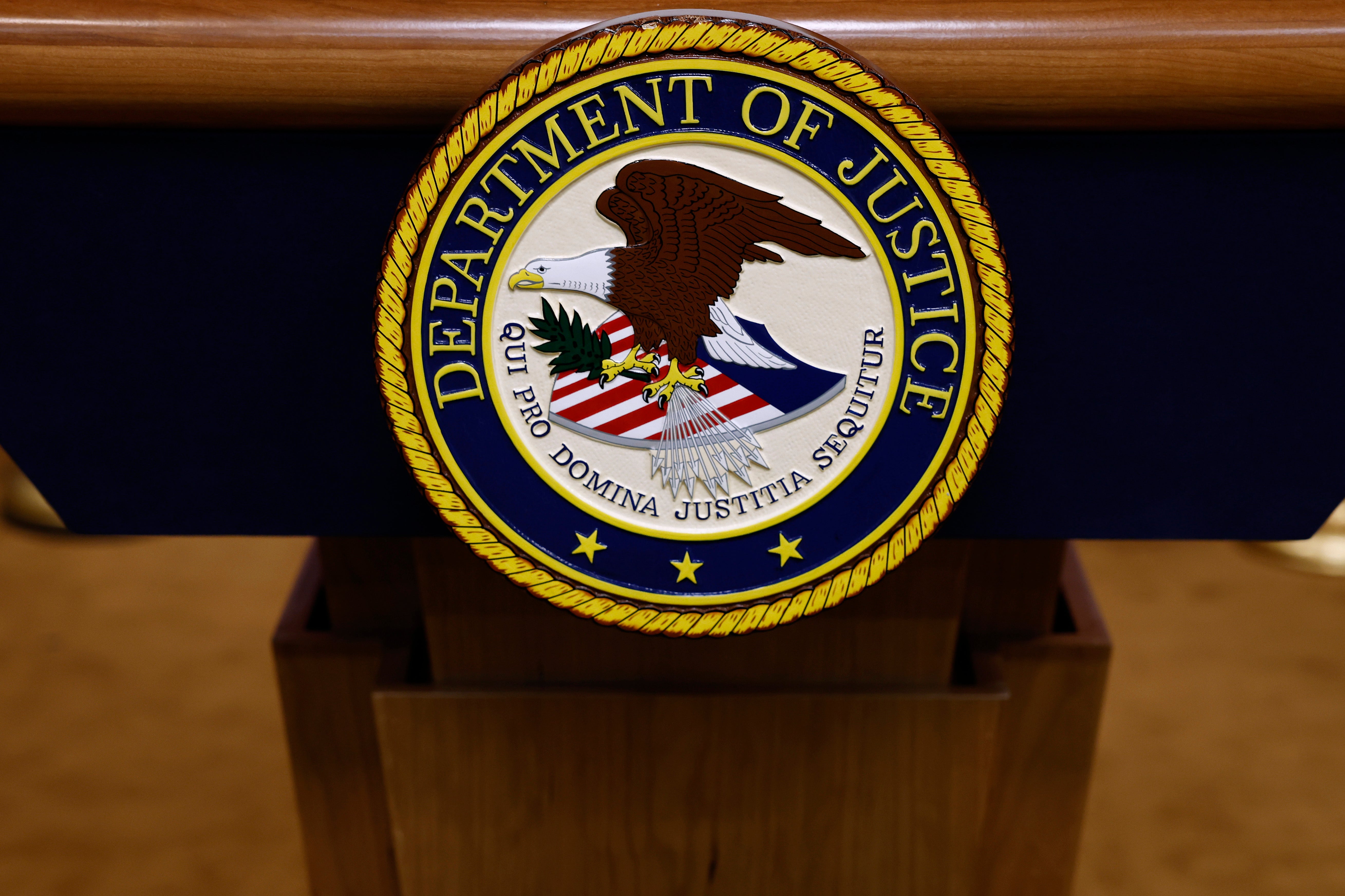 A seal for the Department of Justice is seen on a podium at the Department of Justice Building on March 21, 2024, in Washington, DC. A top spokesperson resigned from the department because of the ‘toxic’ work environment