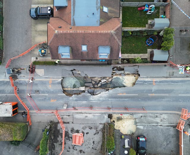 <p>The sinkhole has forced the closure of the high street in Godstone (Jonathan Brady/PA)</p>