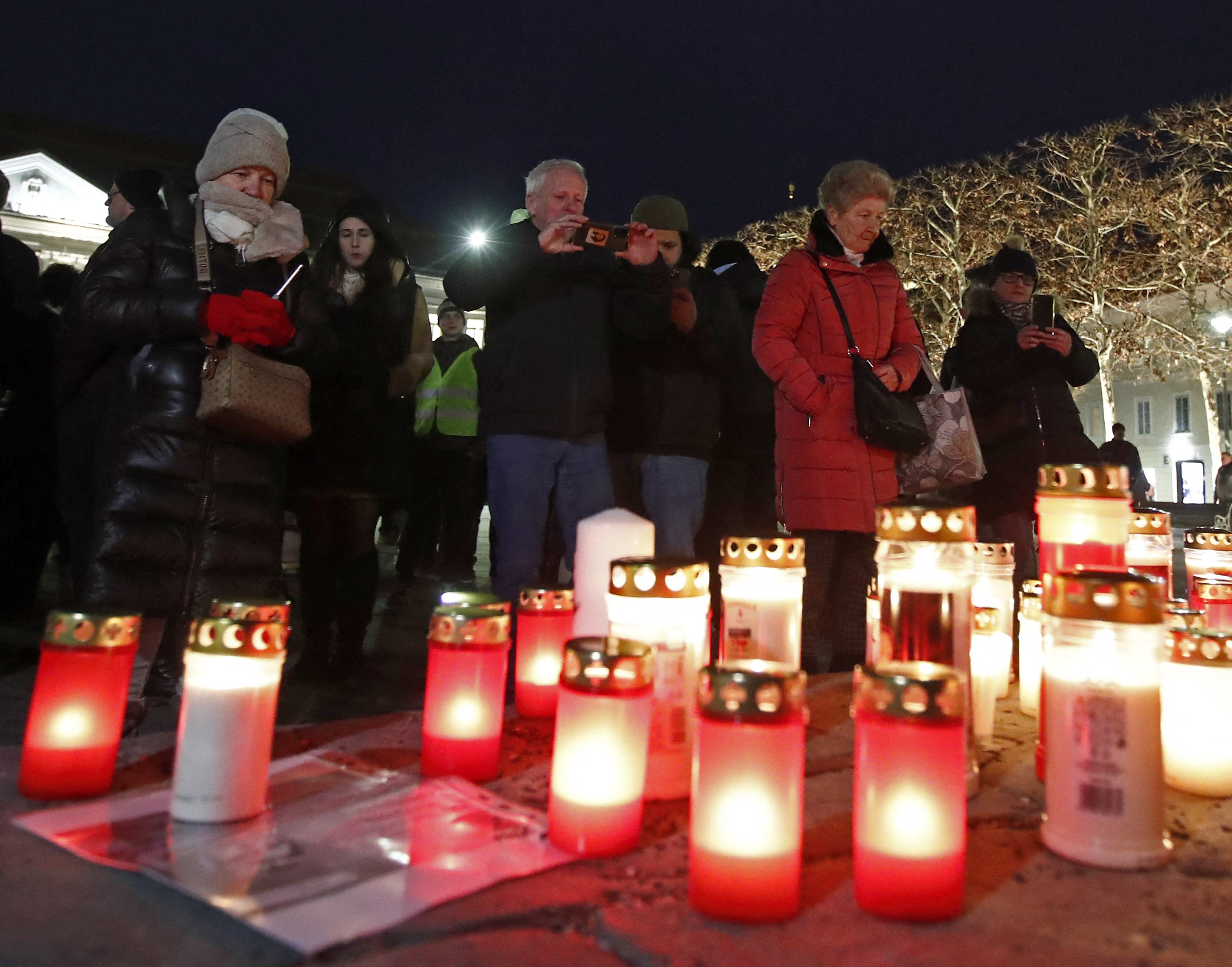 <p>People set up candles to mourn on 17 February 2025 in Klagenfurt, Austria, a town near Villach, where a man randomly attacked passers-by with a knife </p>