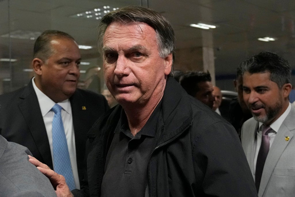 Former Brazilian President Jair Bolsonaro arrives for a luncheon with senators from his support base, at the National Congress building in Brasilia, Brazil, Tuesday, Feb. 18, 2025