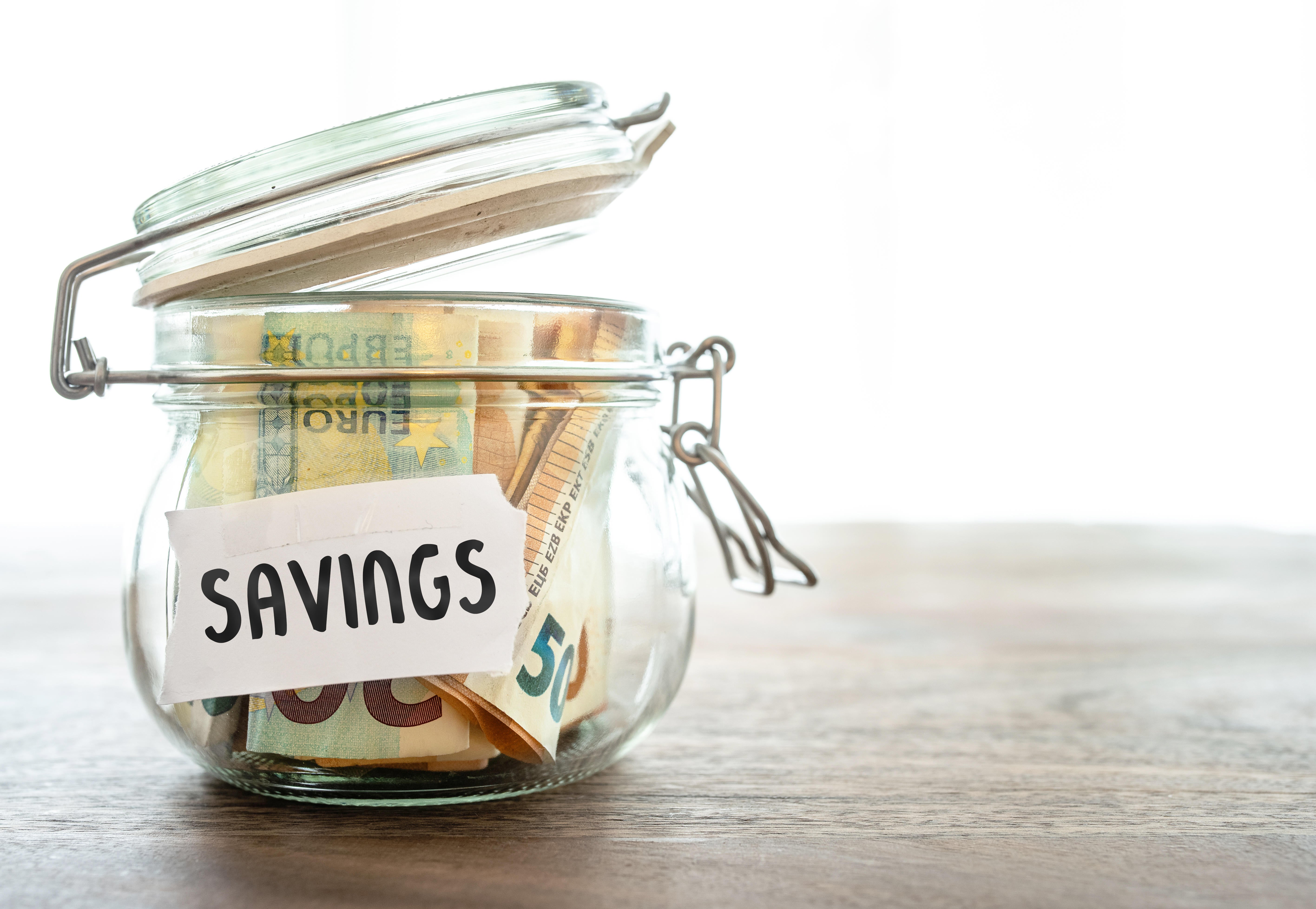 Cash stored in glass jar on a table called Savings (Alamy/PA)