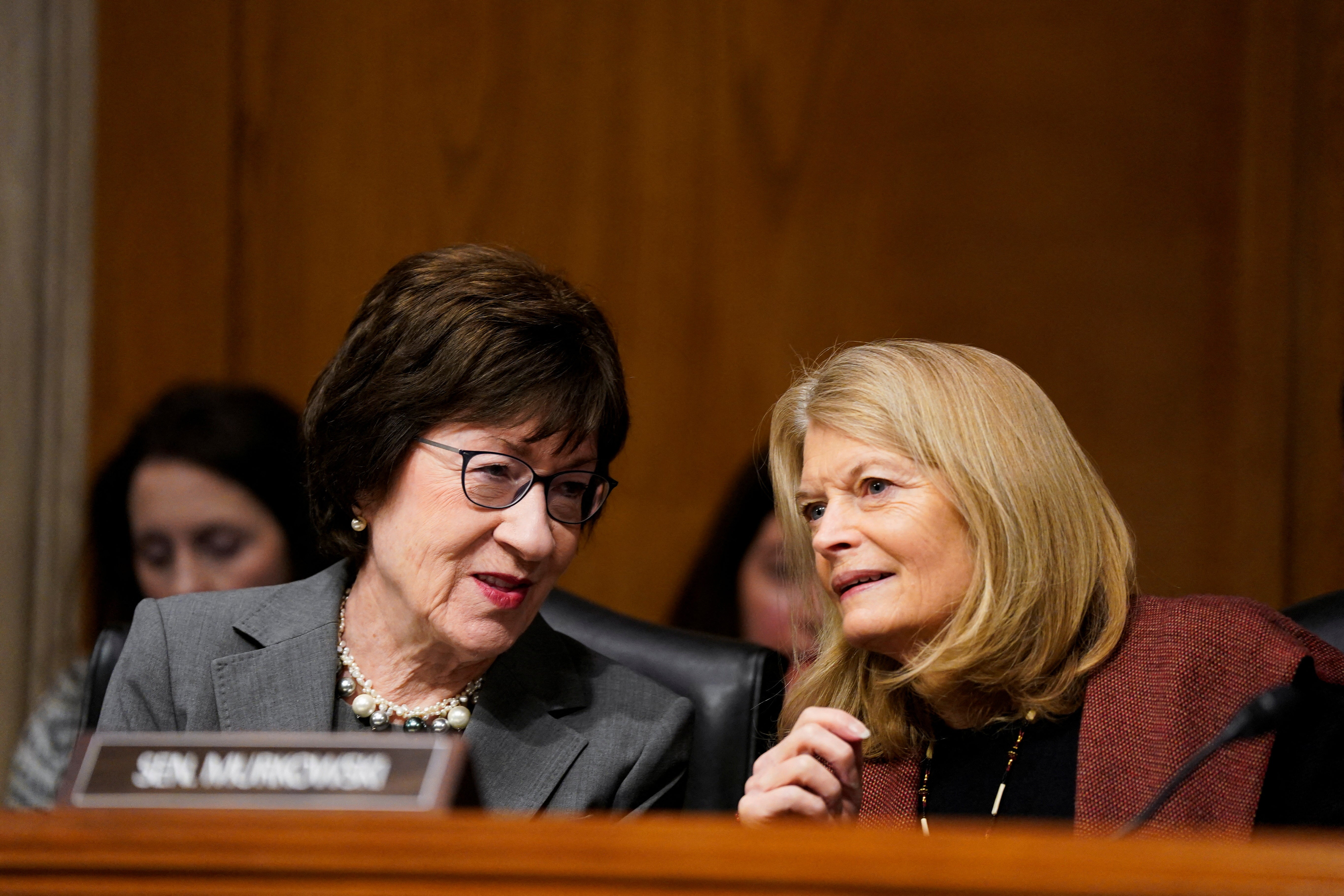 Senator Susan Collins (left) speaks with Senator Lisa Murkowski during a Senate confirmation hearing. The GOP senators have warned about the consequences of DOGE's hasty moves