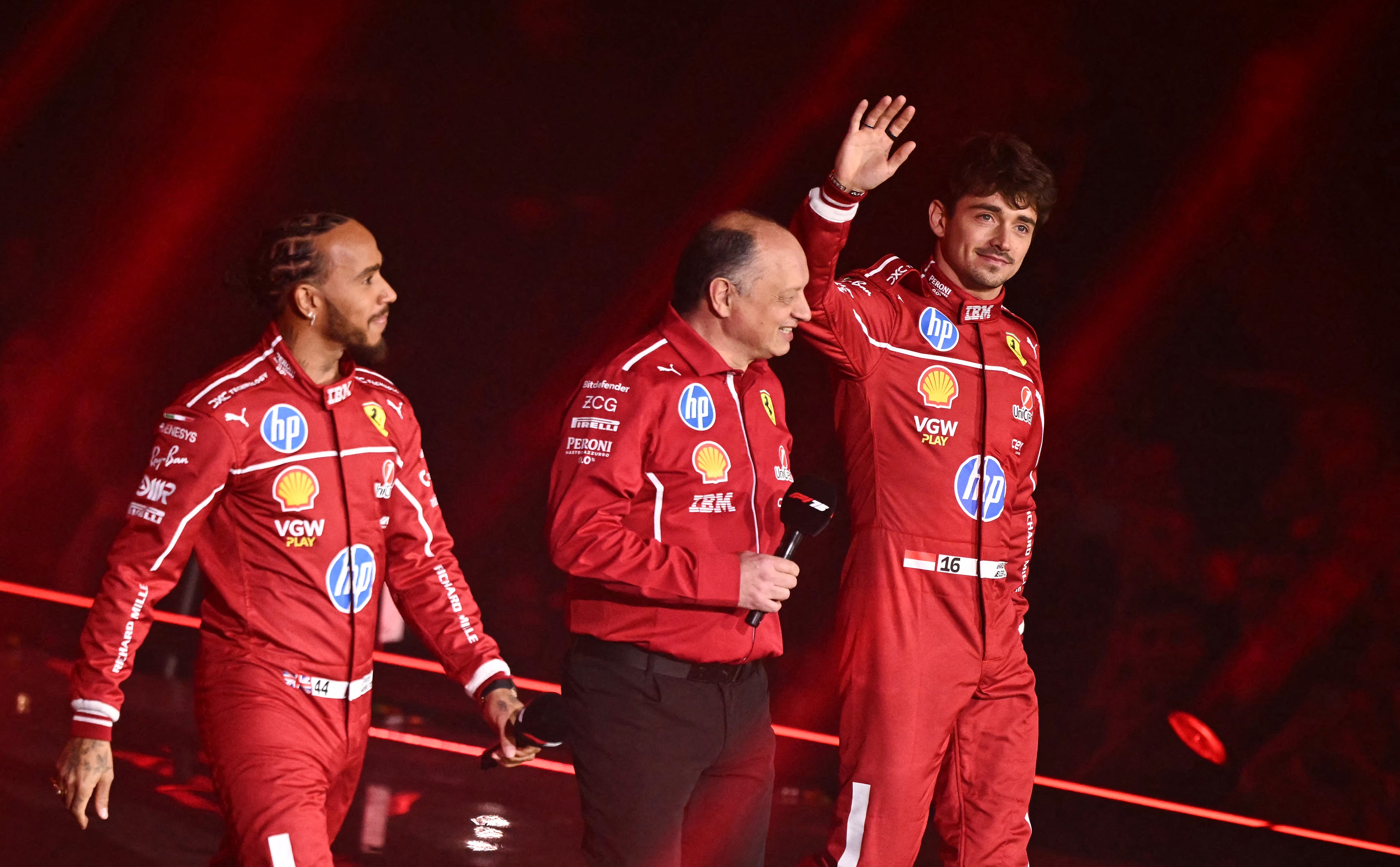 Hamilton with teammate Charles Leclerc (right) and team boss Fred Vasseur (centre) at F1 75 Live in London