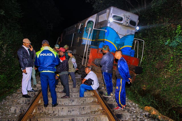 <p>Police and railway personnel examine a derailed train at Habarana in eastern Sri Lanka which killed six elephants</p>
