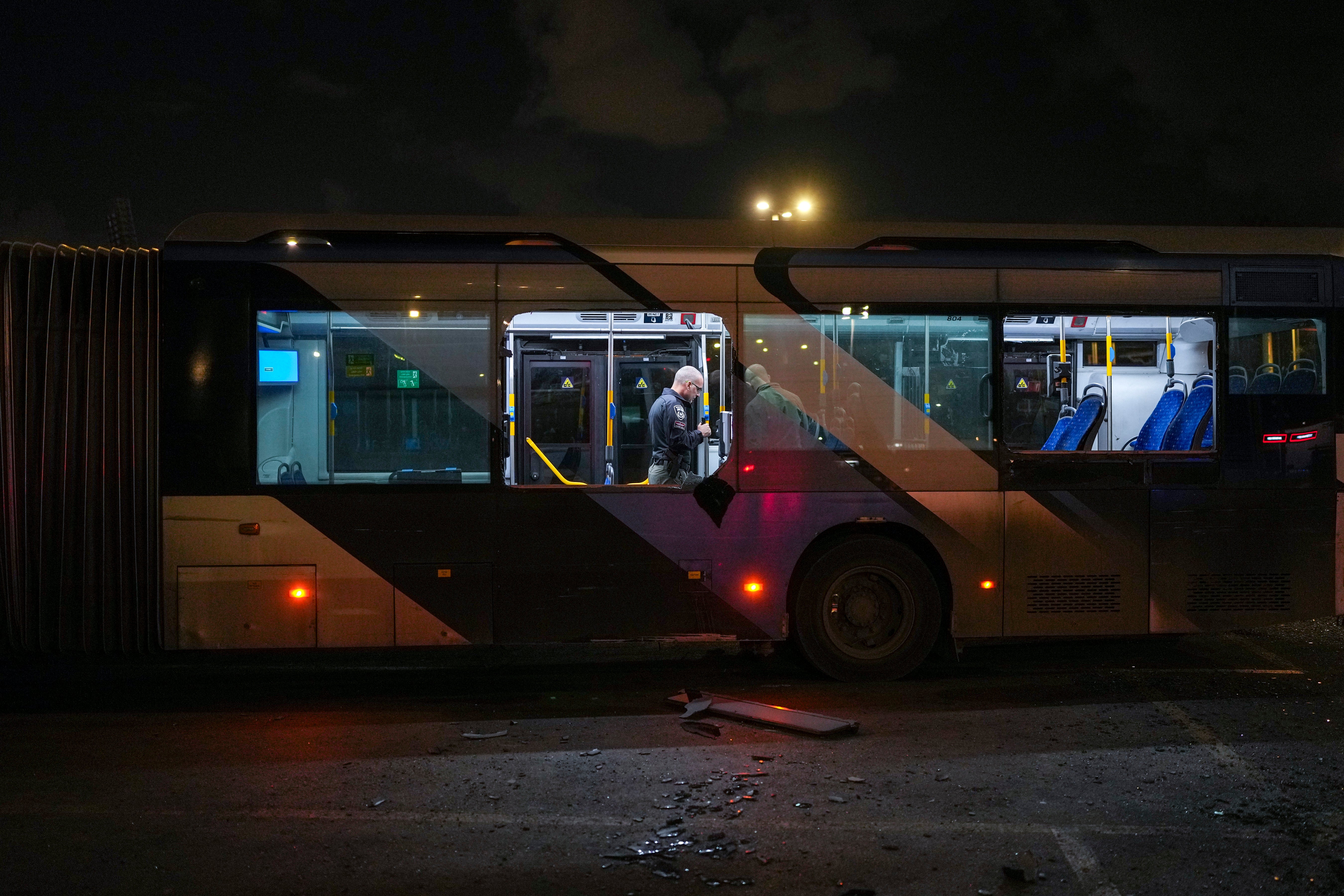 <p>Israeli police search a bus following explosions being treated as a terror attack</p>