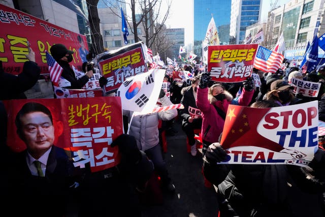 <p>Supporters of impeached South Korean president Yoon Suk Yeol stage a rally to oppose his impeachment near the Seoul Central District Court</p>