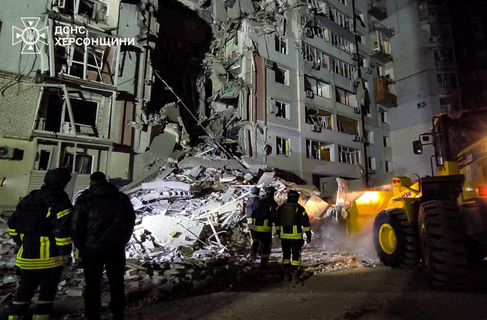 <p>File. Rescue workers outside a building hit by a Russian jet in Kherson</p>