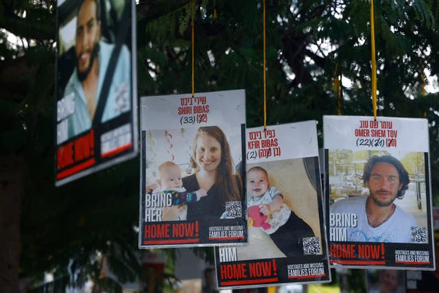 <p>Poster of hostages Shiri Bibas, Kfir Bibas and Omer Shem Tov are displayed in Hostages Square in Tel Aviv</p>