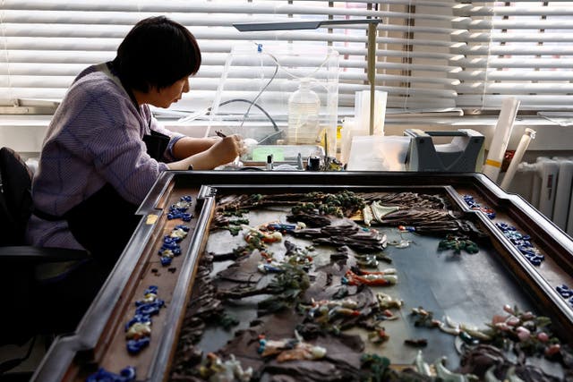 <p>A conservator restores a cultural relic at the cultural protection and restoration department of the Palace Museum at the Forbidden City</p>