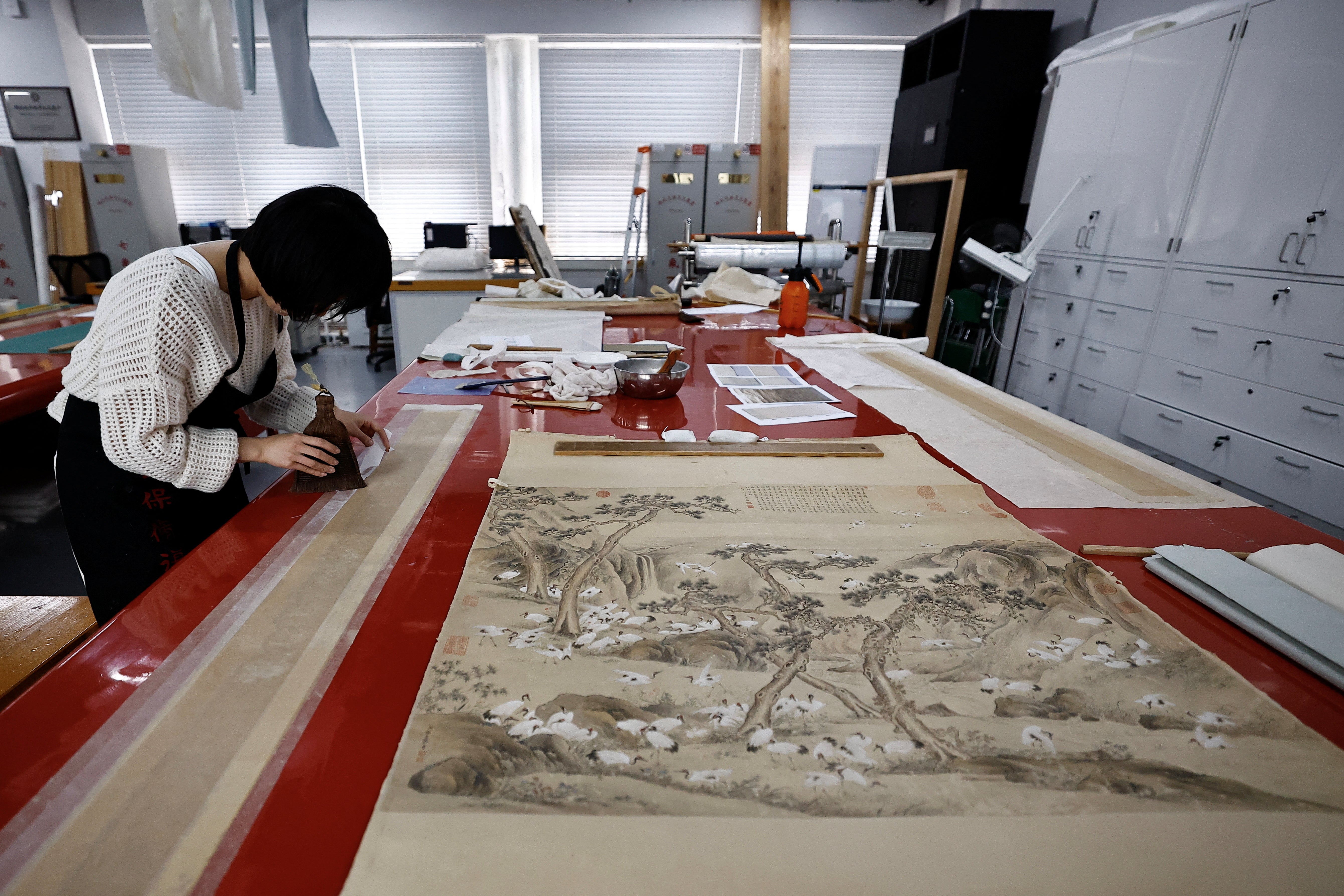 A conservator at work during an organised media tour in Beijing