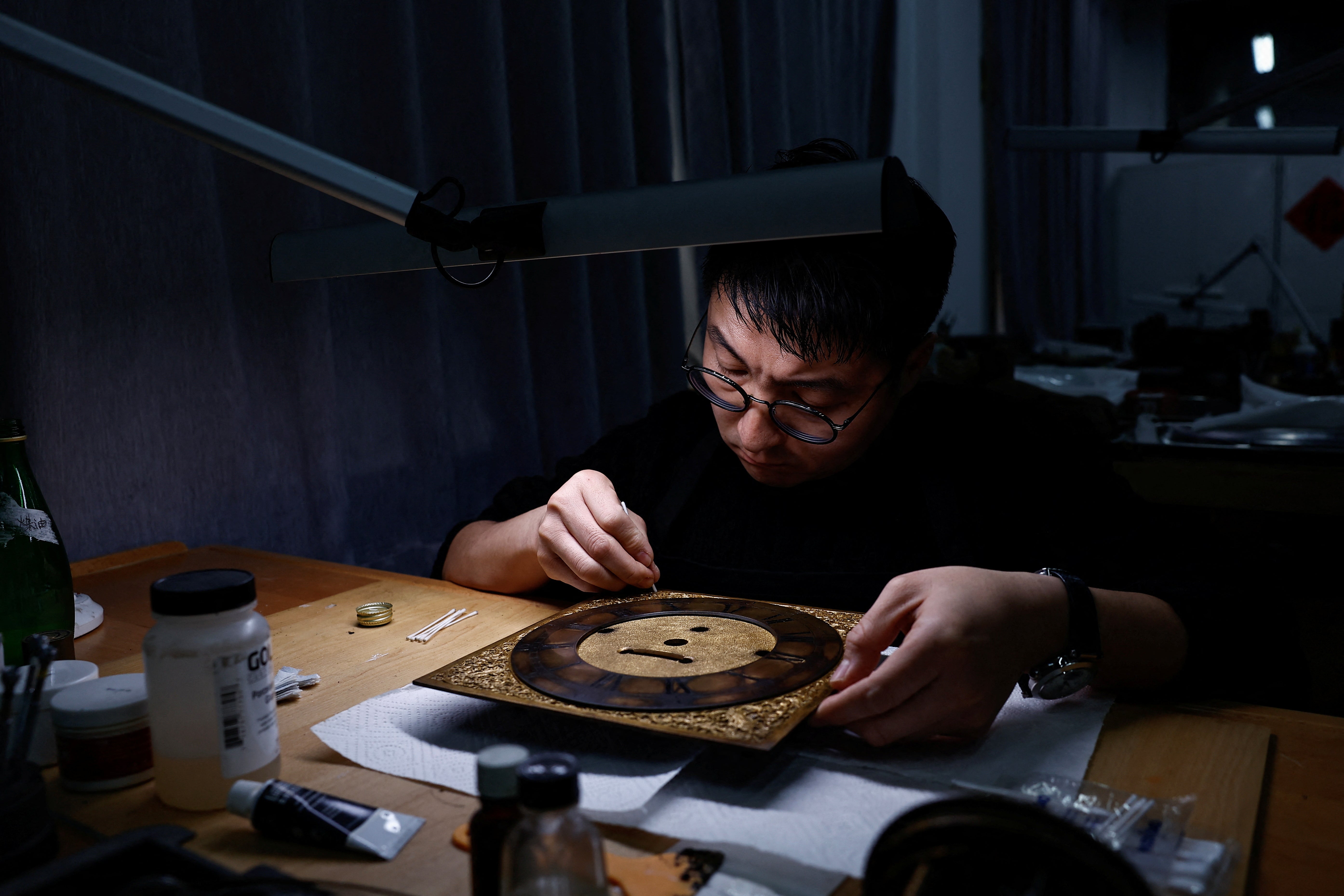 A conservator restores a mechanical artefact