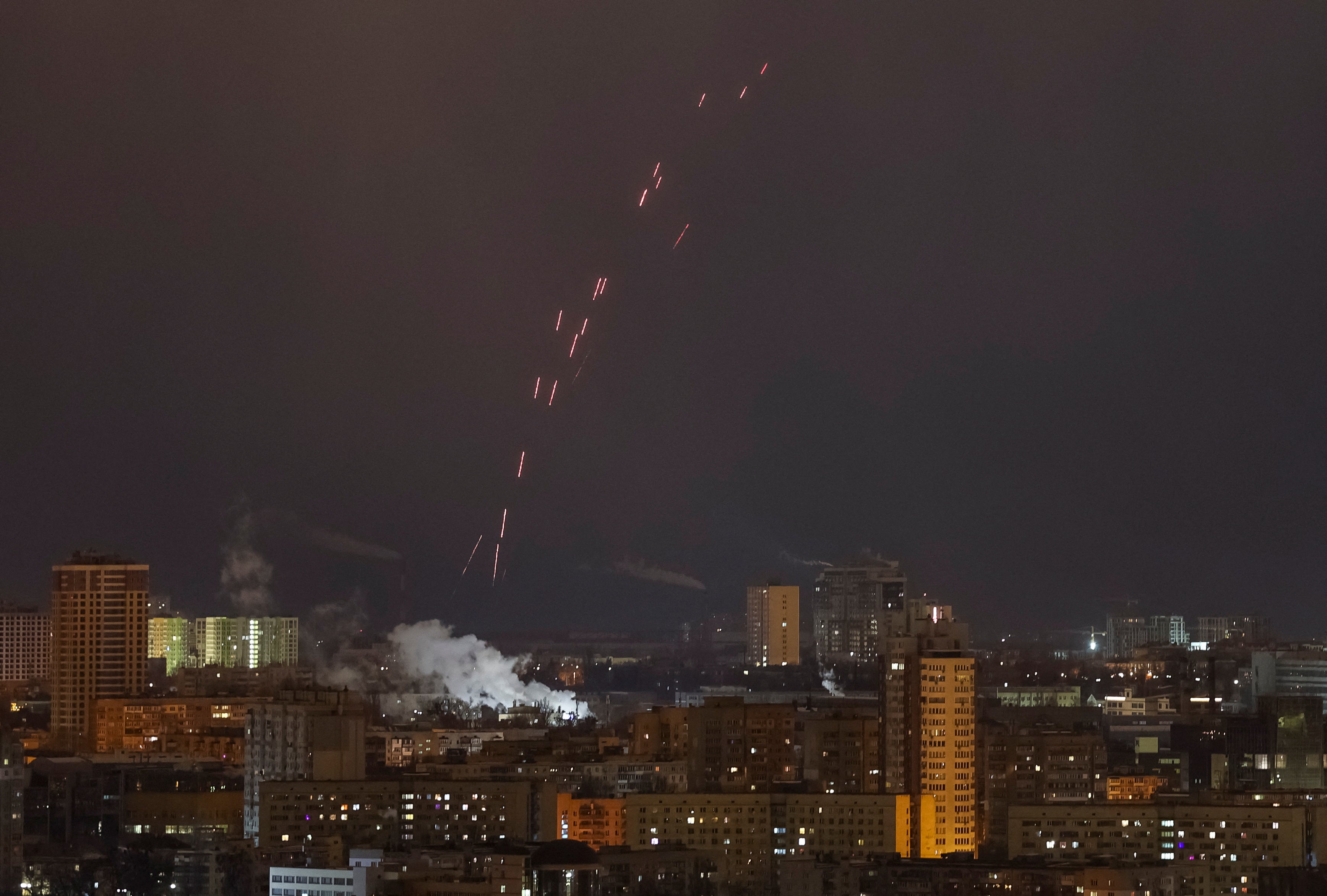 Tracers are seen in the night sky as Ukrainian servicemen fire at the drone during a Russian drone strike, amid Russia's attack on Ukraine, in Kyiv, Ukraine February 21