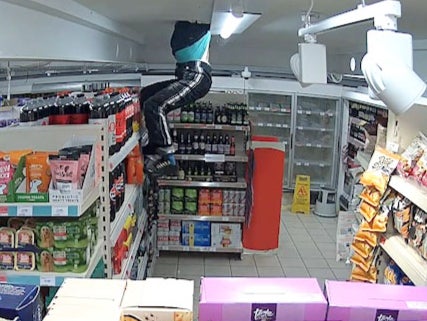 <p>Moment Sainsbury’s thief climbs through store roof to raid shelves</p>