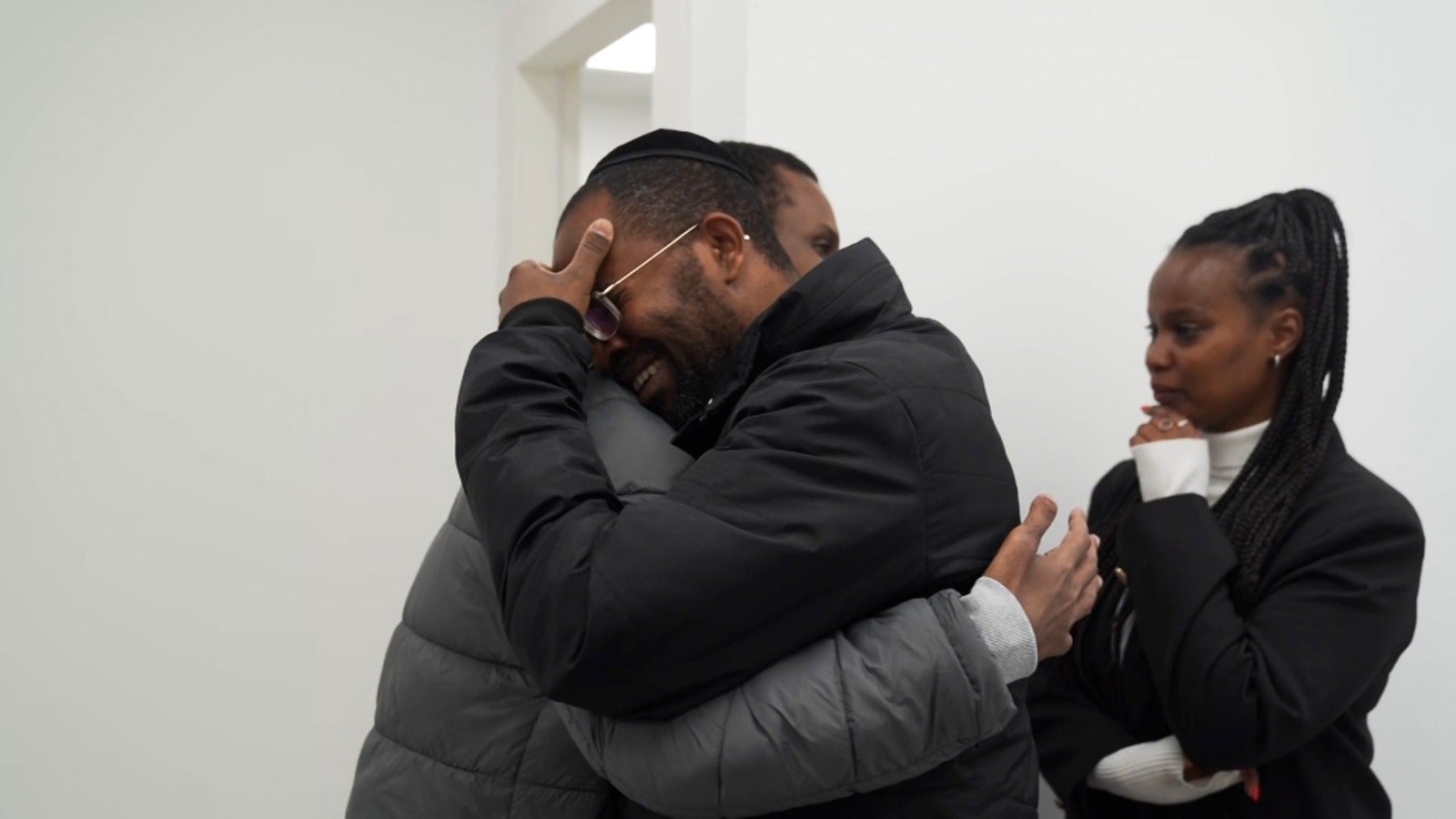 Mr Mengistu embraces a family member after Saturday's handover of hostages