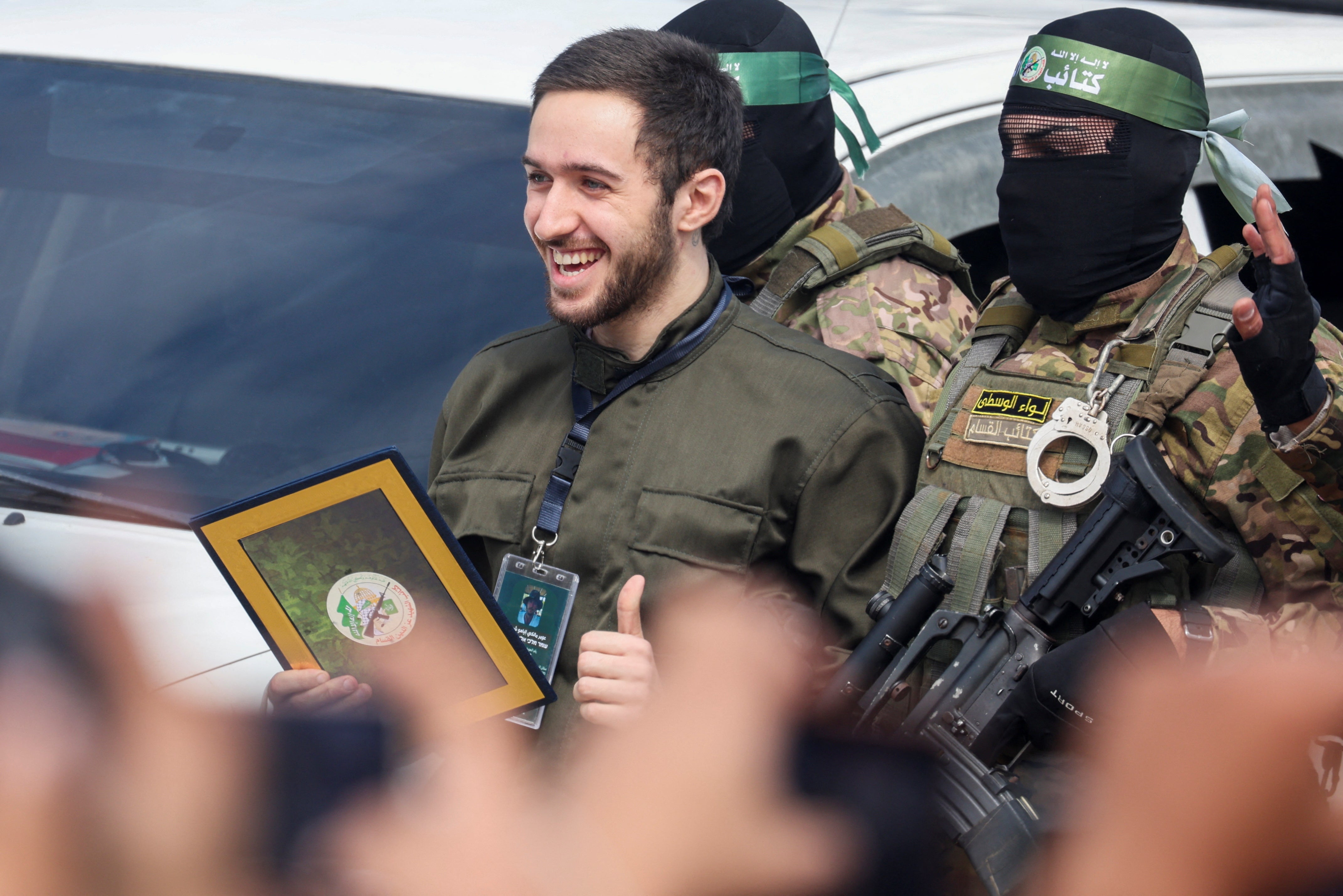 Omer Shem Tov, a hostage held in Gaza is escorted by Hamas militants