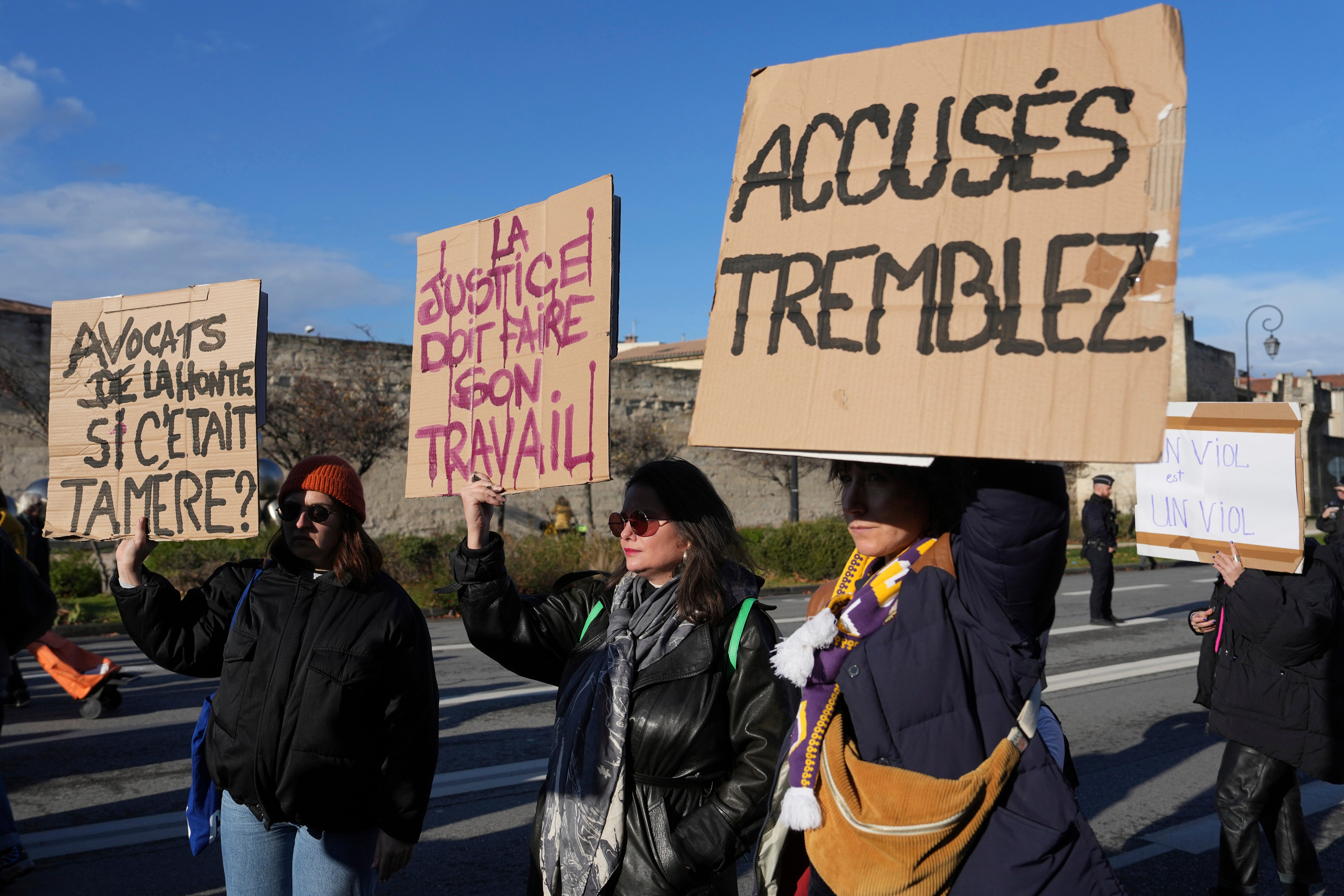 Activists hold posters during a women’s rights demonstration, Dec. 14, 2024 in Avignon, southern France,