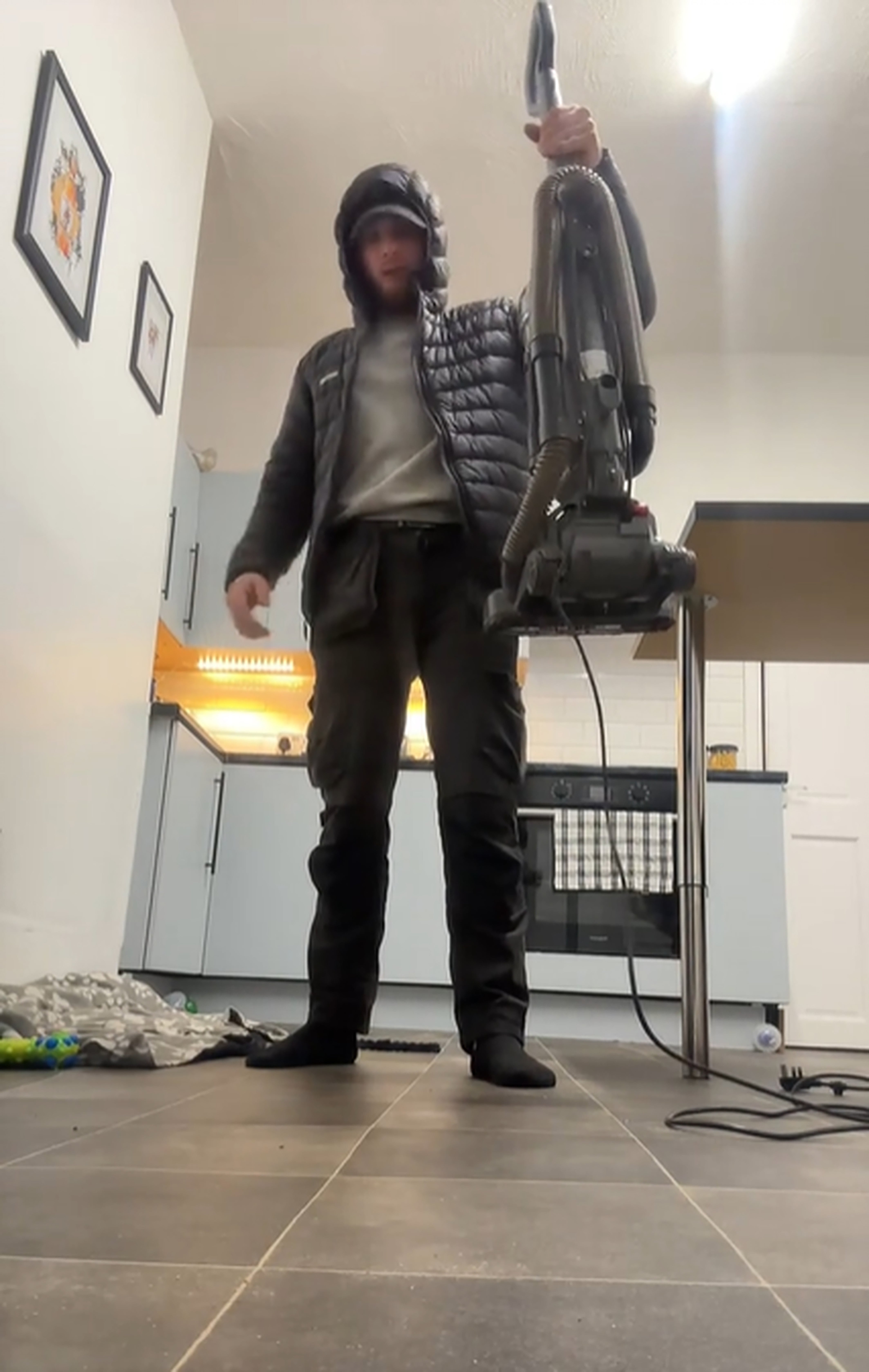 Screen grab taken from undated video issued by TikTok user Luke Pilling of himself taking part in a viral TikTok trend involving people dropping heavy objects, such as air fryers, toasters and vacuum cleaners, on their feet