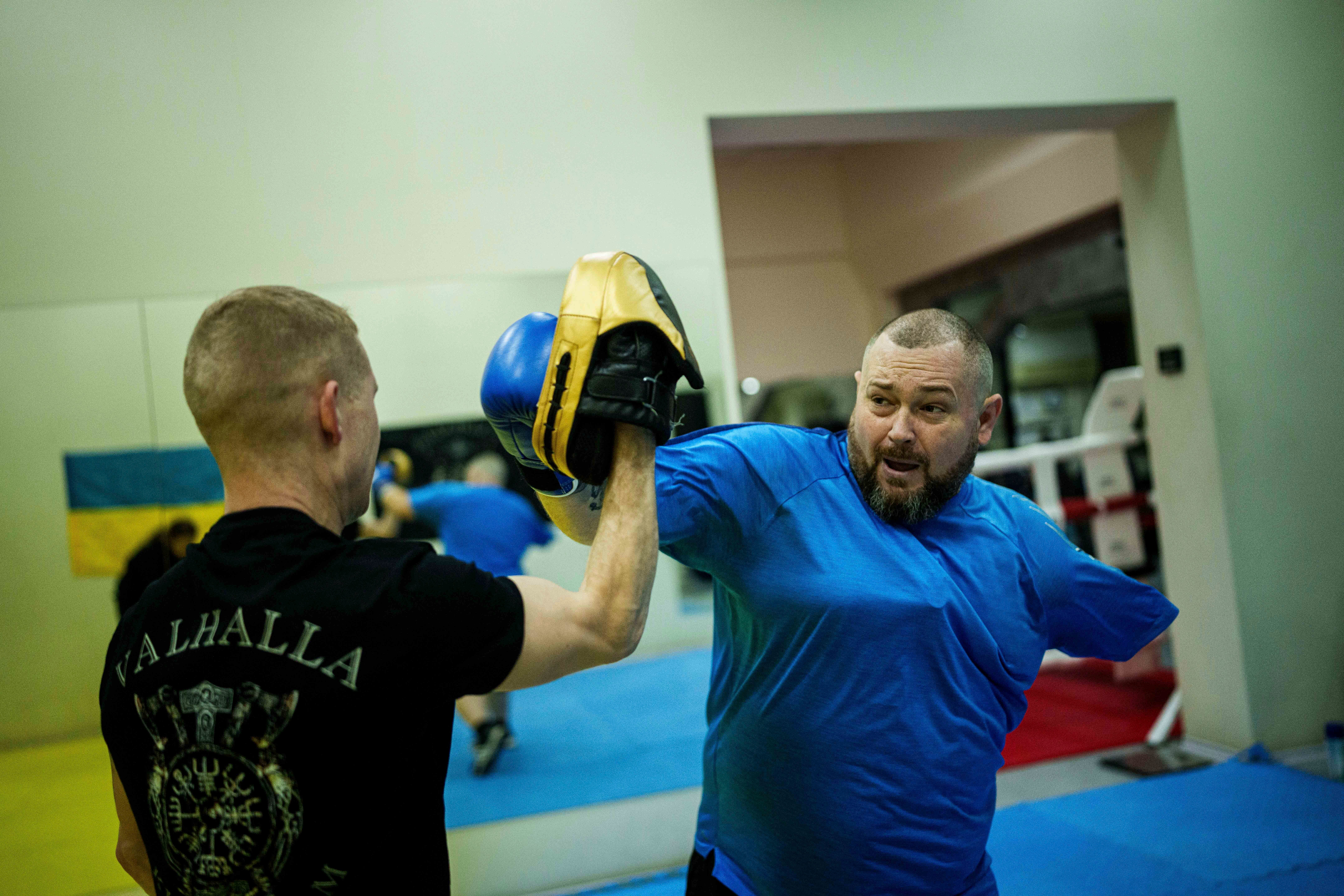 Oleksandr Puzikov, a captain with Ukraine’s 127th brigade who lost an arm in a Russian mortar attack, trains at a gym